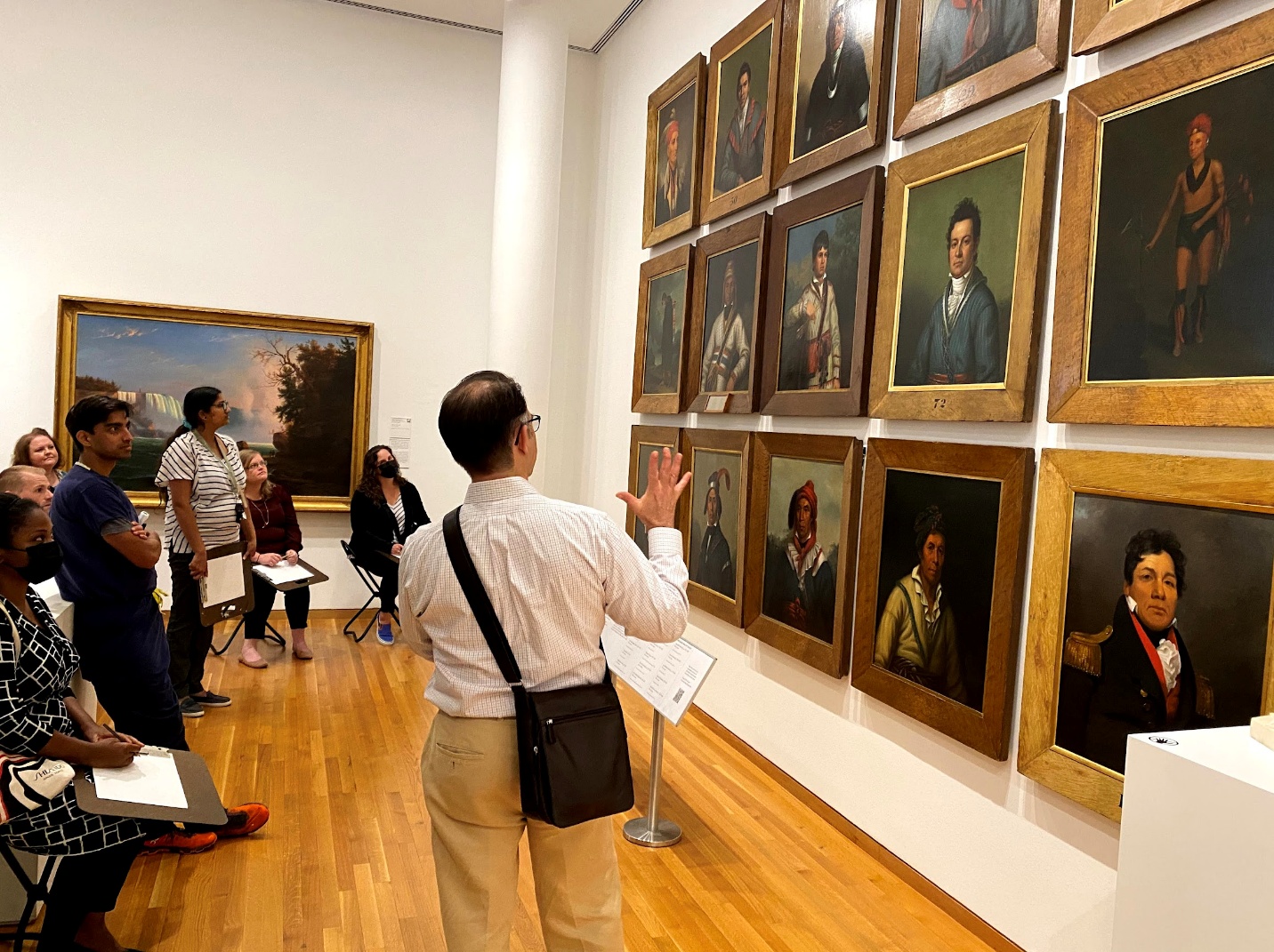 A person looking at a piece of art in a museum Description automatically generated with low confidence